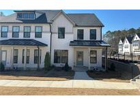 New construction two-story townhome showing front exterior with black trim windows and a landscaped yard at 400 Renwood Trl, Johns Creek, GA 30097