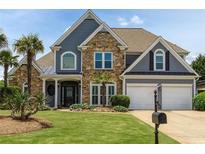 Charming two-story home with stone and siding, manicured lawn, and a two-car garage at 820 Nob Ridge Dr, Marietta, GA 30064