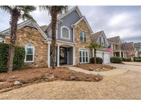 Charming two-story home featuring a stone facade, arched windows, and a welcoming front entrance at 820 Nob Ridge Dr, Marietta, GA 30064