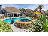 Stunning backyard featuring a sparkling pool and spa, perfect for relaxation and entertaining at 820 Nob Ridge Dr, Marietta, GA 30064
