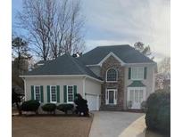 Charming two-story home features stone accents, green shutters, and an attached two-car garage at 2860 Pine St, Duluth, GA 30096