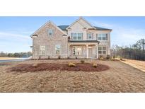 Stunning two-story brick home with a welcoming front porch and manicured landscaping at 800 Dobby Way (Lot 104), Mcdonough, GA 30252