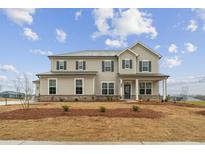 Charming two-story home featuring a symmetrical facade, complemented by dark shutters and a well-manicured front lawn at 267 Arwen Drive (Lot 66), Mcdonough, GA 30252