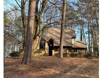 Charming brick home nestled among mature trees, offering privacy and a tranquil setting at 4200 Shire Ne Ct, Roswell, GA 30075