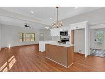 Open concept kitchen featuring a large island, modern appliances, and a light and airy feel at 436 Tarpley Ave, Bowdon, GA 30108