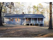 Charming single-story home with a welcoming front porch and beautiful natural surroundings at 823 Mount Tabor Rd, Oxford, GA 30054