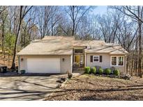 Charming single-story home with a two-car garage and well-manicured landscaping at 920 Pine Grove Pointe Dr, Roswell, GA 30075