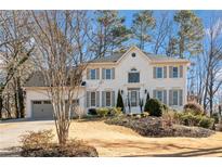 Charming white brick home with well-manicured lawn, mature trees, and a two-car garage at 2833 Landing Way, Marietta, GA 30066