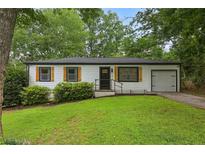 Charming single-story home featuring a well-manicured lawn, tasteful shutters, and a welcoming front entrance at 3314 Creatwood Se Trl, Smyrna, GA 30080