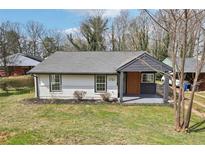Charming bungalow featuring a freshly painted exterior, manicured lawn, and welcoming front porch at 1751 Carter Cir, Atlanta, GA 30344