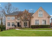 Charming two-story home with manicured lawn, elegant windows and a well-maintained landscape at 551 Straton Chase Se, Marietta, GA 30067