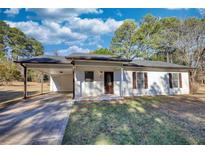Charming single-story home featuring a carport, neutral siding, and well-manicured lawn at 61 Andrew Rd, Covington, GA 30016