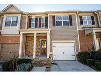 Charming townhome featuring stone accents, attached garages, and well-maintained landscaping at 2715 Maple Park Pl # 30, Cumming, GA 30041