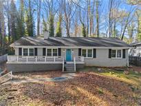 Charming single-story home with a welcoming front porch and a beautifully landscaped front yard at 2790 Collier Nw Dr, Atlanta, GA 30318