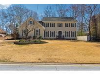 Traditional two-story home featuring a symmetrical facade, shutters, and a well-maintained lawn at 3215 Northbrook Dr, Atlanta, GA 30341