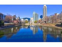 Beautiful aerial view of community pond with a water feature and urban buildings at 260 18Th Nw St # 10302, Atlanta, GA 30363