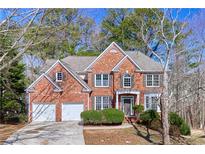 Beautiful brick home featuring a two-car garage and manicured landscaping at 3637 Green Pine Way, Suwanee, GA 30024
