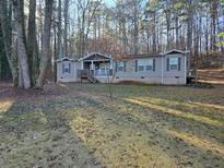 Charming single-story home featuring a welcoming porch and well-maintained front yard at 512 S Holly Springs Rd, Woodstock, GA 30188