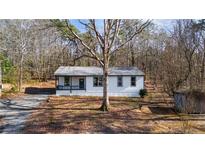 Charming single-story home with a cozy front porch and well-maintained landscaping at 3192 Highway 411 Ne, White, GA 30184