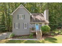 Charming two-story home with gray siding, black shutters and a welcoming light-blue front door at 1056 Ferry Creek Way, Acworth, GA 30102