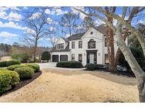 Charming two-story home with a white brick exterior, manicured landscaping, and a two-car garage at 6268 Braidwood Nw Run, Acworth, GA 30101