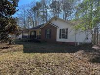 Charming one-story home with brick accents and a cozy front porch, perfect for relaxing at 8951 Brewer Rd, Douglasville, GA 30134