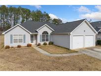 Charming single-story home with a two-car garage and well-maintained front yard at 4768 Score Ct, Snellville, GA 30039