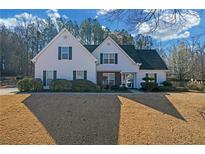 Charming traditional home with well-maintained landscaping and a welcoming front entrance at 115 Trelawney Cir, Covington, GA 30016