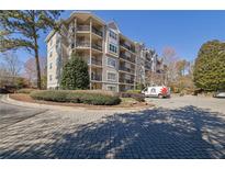 Beautiful condo complex with brick driveway and mature landscaping at 1406 River Green Nw Dr, Atlanta, GA 30327