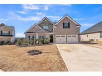 Charming two-story home with a well-maintained lawn and a two-car garage at 1109 Alaska St, Hampton, GA 30228