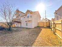 View of the home's backyard with a wooden fence and grassy area on a sunny day at 5546 Wellborn Creek Dr, Lithonia, GA 30058