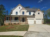 Beautiful two-story home featuring a brick and siding exterior with a welcoming front porch at 3677 Thornhill Ct, Douglasville, GA 30135