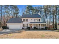 Charming two-story home with a welcoming front porch and well-maintained landscaping at 1015 Country Walk Ct, Lawrenceville, GA 30043