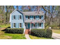 Charming two-story home with light blue siding, blue shutters, and a welcoming front porch at 1440 Churchill Way, Marietta, GA 30062