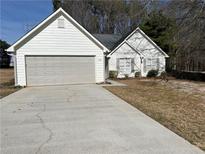 Charming single-story home with a two-car garage and well-maintained front lawn at 504 Chase Ct, Loganville, GA 30052