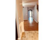 Inviting hallway featuring hardwood floors and neutral walls leading to a bright, open space at 1290 Adcox Sq, Stone Mountain, GA 30088