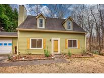 Charming two-story home with dormer windows, yellow shutters, and a well-maintained front yard at 1535 Willow Gate Trace, Auburn, GA 30011