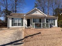 Charming single-story home with neutral siding, large windows, and a cozy front porch at 6163 Princeton Ave, Morrow, GA 30260