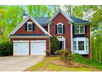Charming two-story brick home featuring a two-car garage and well-maintained landscaping at 6302 Manassas Nw Pass, Acworth, GA 30101