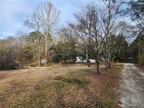 Charming home nestled in a wooded area, surrounded by mature trees offering privacy at 1619 Flowery Branch Rd, Auburn, GA 30011
