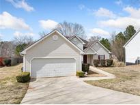 Charming single-Gathering home with a well-maintained lawn and a two-car garage at 4477 James Wade Dr, Snellville, GA 30039