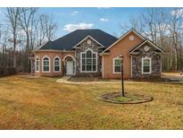Charming one-story home featuring stone accents, arched windows, and a well-manicured lawn at 429 Telluride Ct, Locust Grove, GA 30248