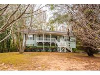Charming home featuring a well-kept lawn and inviting front porch at 476 Cody Ln, Douglasville, GA 30134