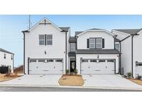 Charming new construction townhomes featuring a two-car garage and modern farmhouse architecture at 6363 Apalachee Se Way, Smyrna, GA 30126
