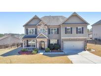 Charming two-story home featuring a combination of brick and siding accents, plus a manicured front lawn at 38 Water Oak Dr, Acworth, GA 30101