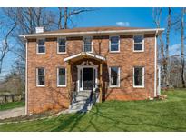 Beautiful two-story brick home featuring a covered front porch, steps, and a well-manicured lawn at 5137 Belvedere Dr, Stone Mountain, GA 30087