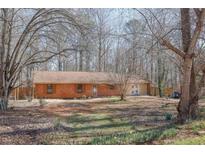 Charming brick home with a well-maintained front yard and mature trees providing shade and privacy at 260 Apalachee Church Rd, Auburn, GA 30011