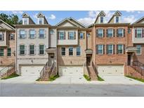 Beautiful brick townhomes with individual garages, entry stairs, and welcoming facade at 3139 Boldmere Se Trl, Smyrna, GA 30080