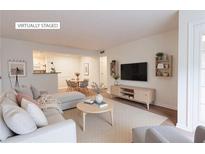Bright living room featuring hardwood floors, modern furnishings, and an open floor plan at 3064 Chastain Park Ne Ct, Atlanta, GA 30342