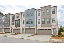 Charming townhome exterior with a private garage, landscaped yard, and stylish modern architecture at 2758 Maddison Towns Ave, Norcross, GA 30071